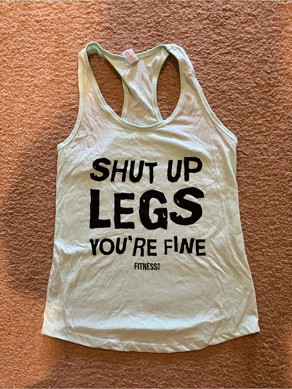 Fitness by Ideal light green tank top with black text 'SHUT UP LEGS' size M